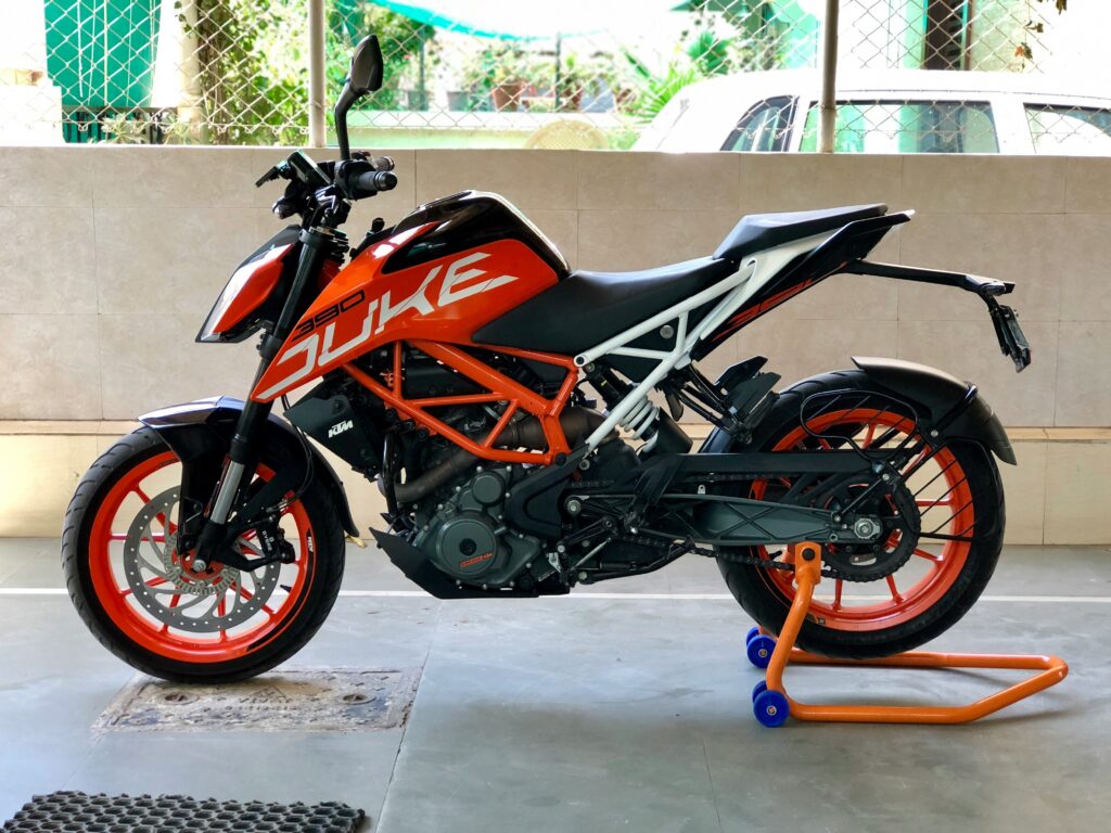 KTM 390 Duke 2024 model in Electric Orange Metallic showcasing aggressive design, powerful 398.63cc engine, and advanced features like traction control and cornering ABS.
